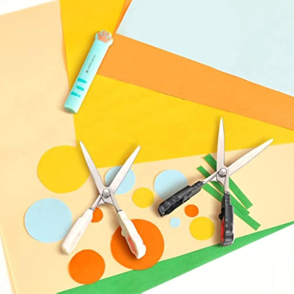 Closed cat paw mini folding scissors showing stainless steel blades and coloured handles.