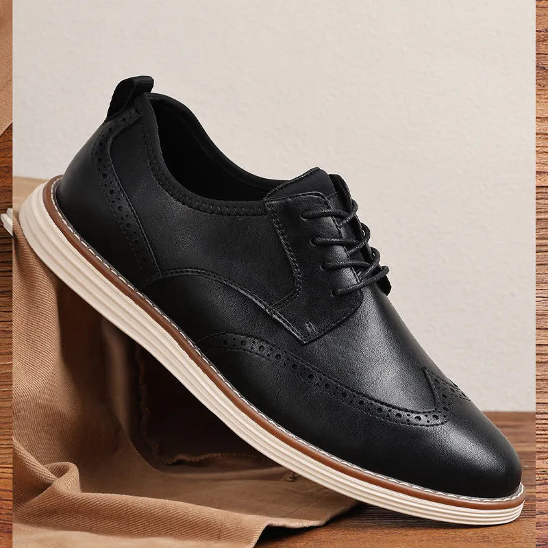 Men's black slip-on business casual shoe with round toe and carved PU upper detail on a TPR sole.
