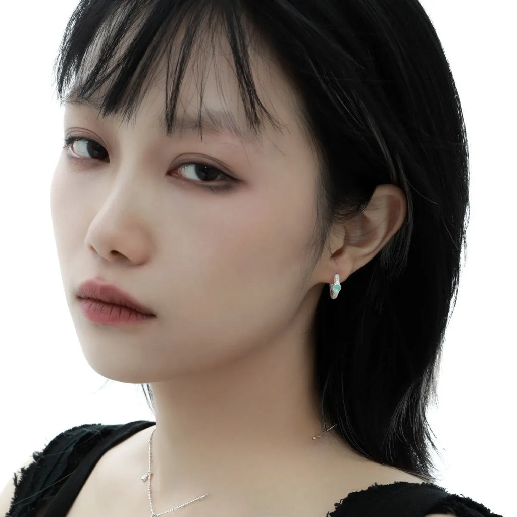 Burnt silver geometric circle ear clips for women made from 925 sterling silver.