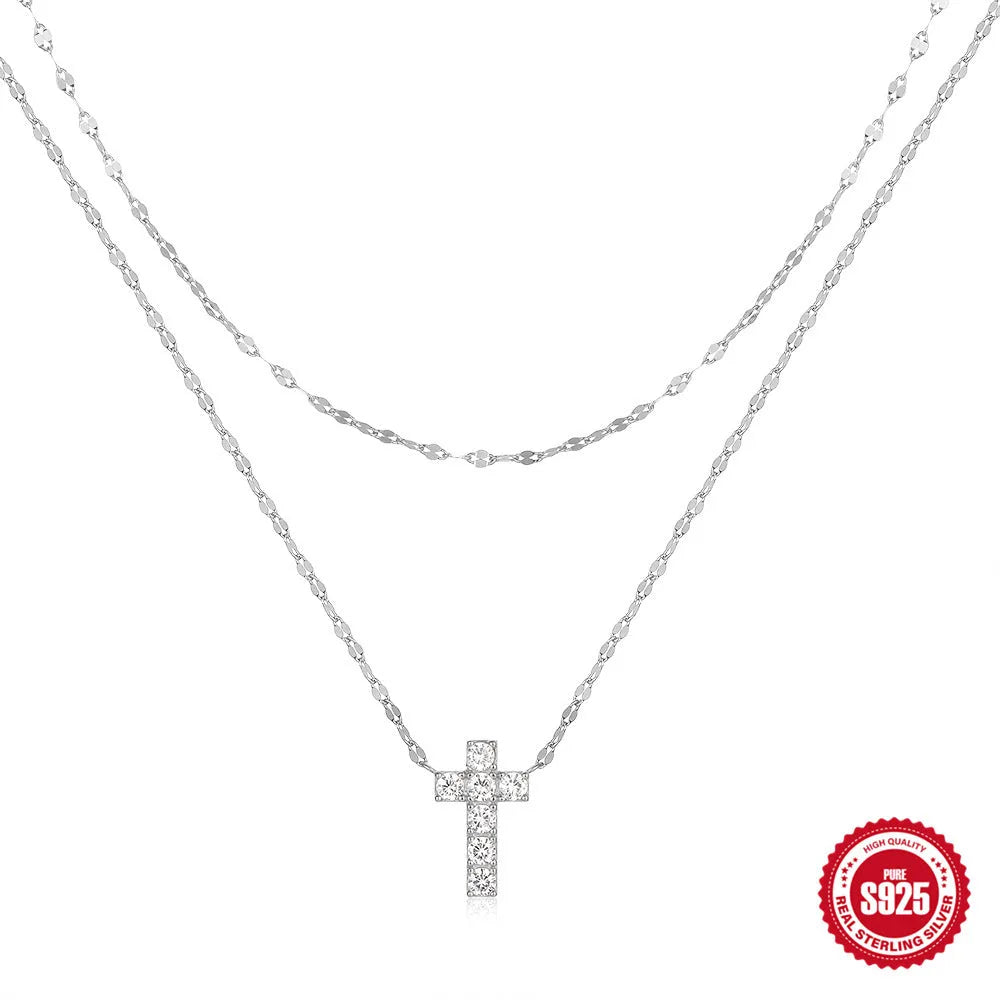 Sterling silver double layer twin diamond cross necklace on a clavicle chain, shown in gold tone.