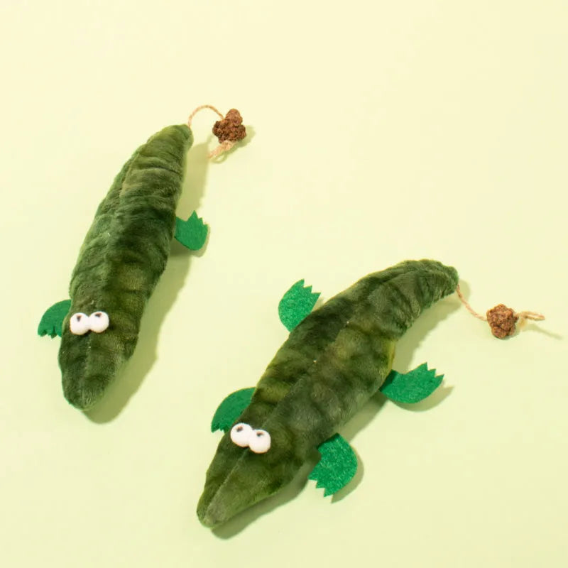 Green plush alligator catnip toy with peppermint scent for feline oral cleansing