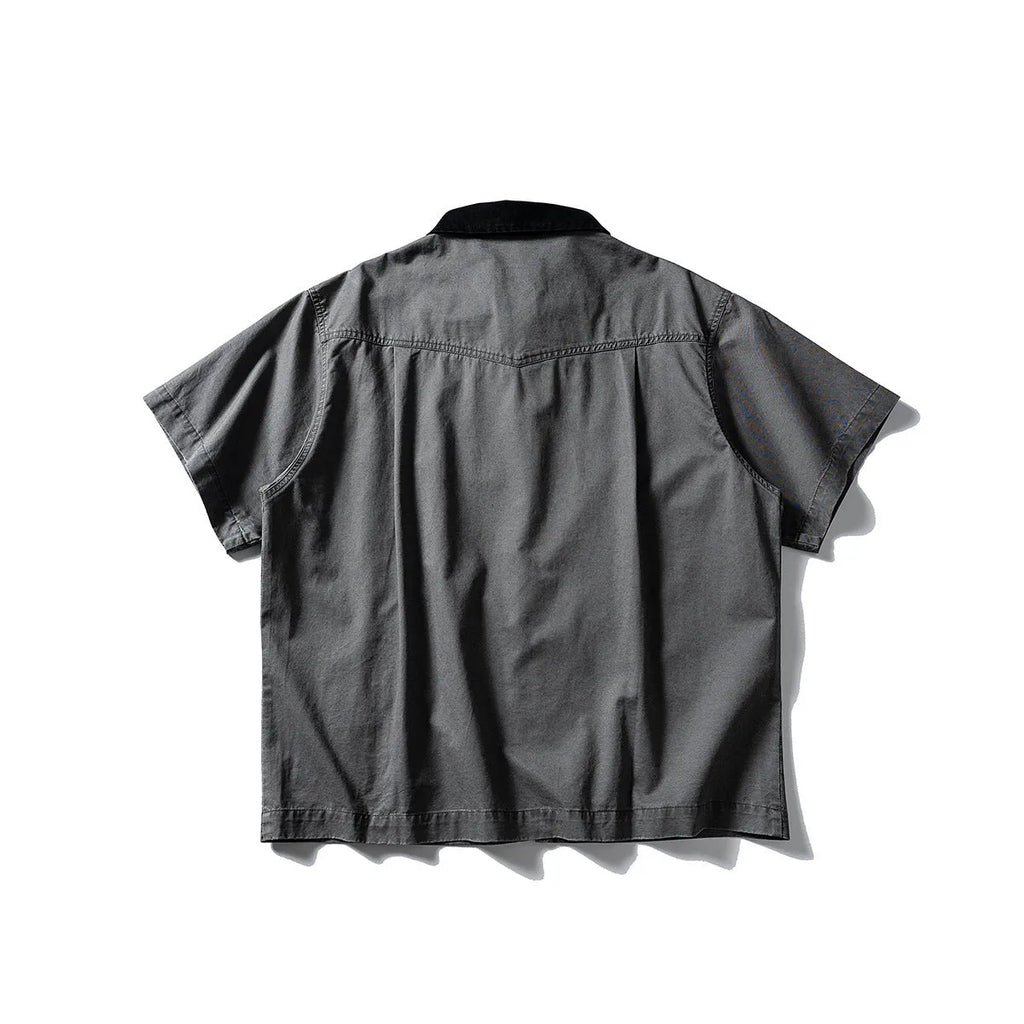 Washed khaki cotton overalls shirt with short sleeves and loose cardigan style on a hanger