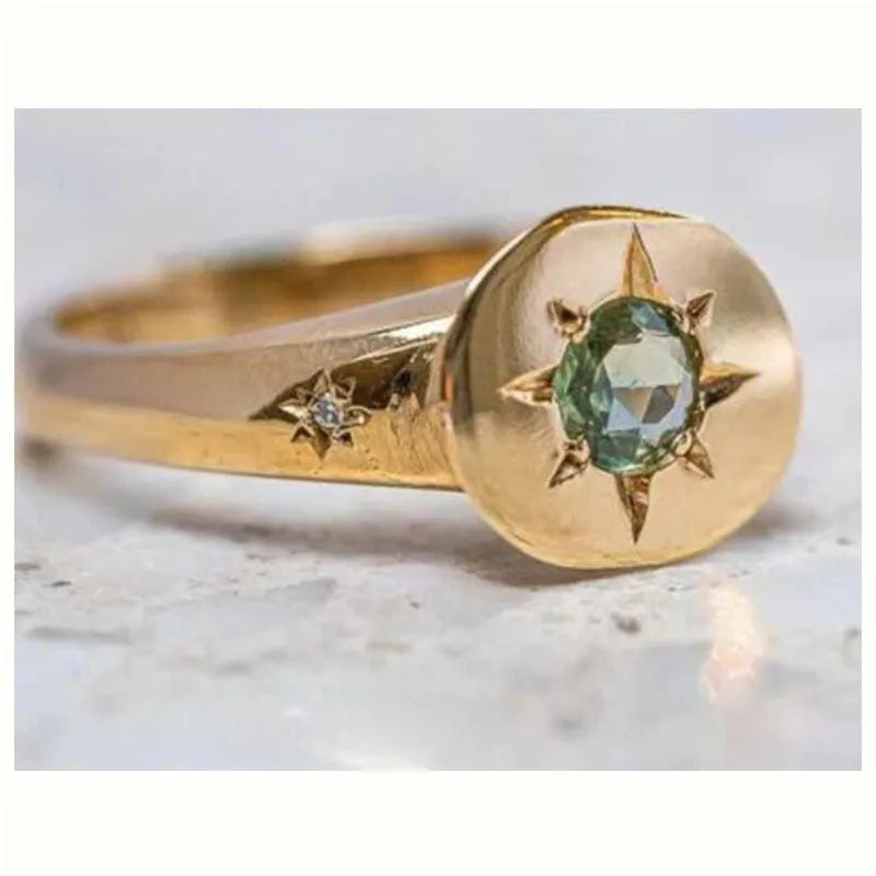 Golden adjustable ring with oval face featuring detailed star inlay design