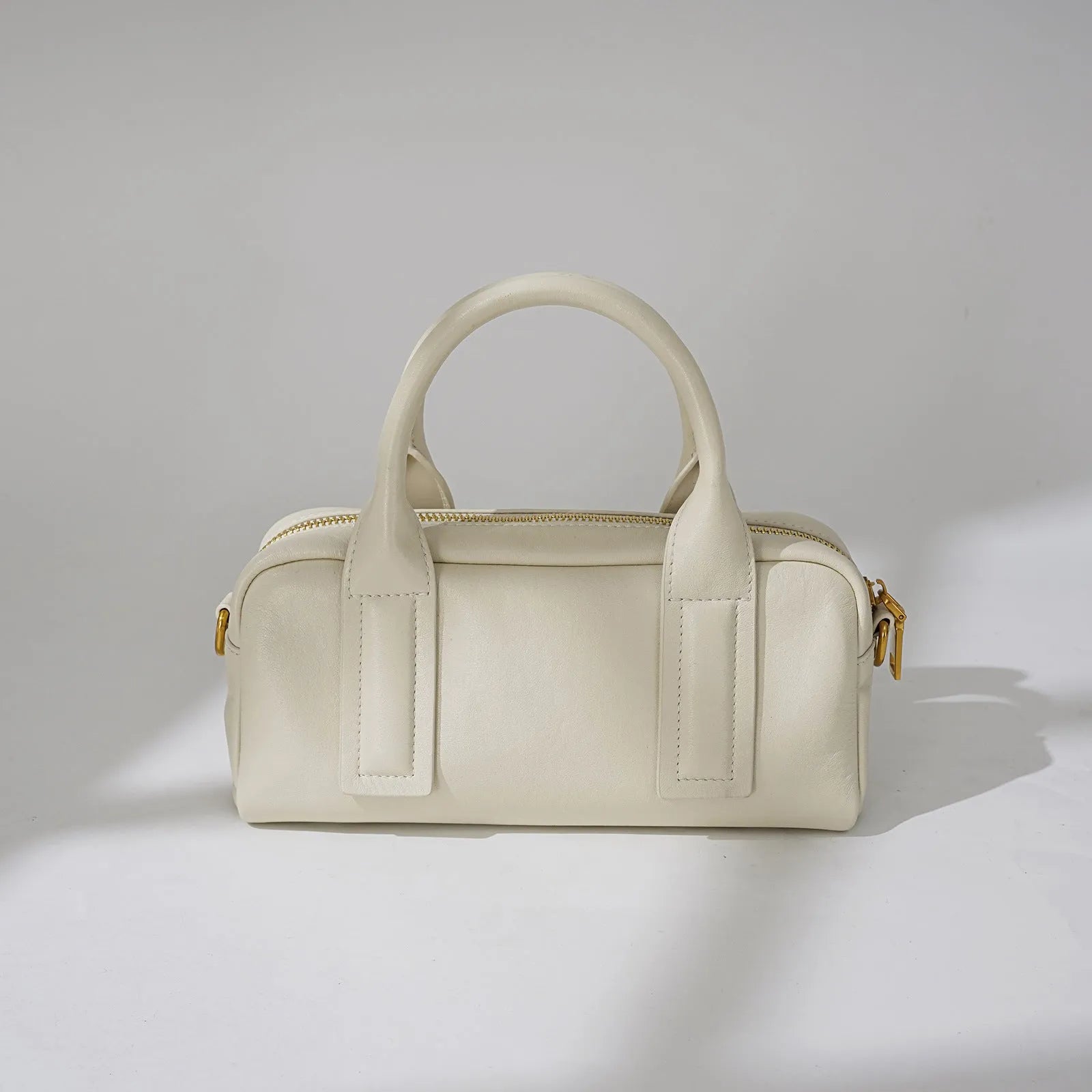Genuine first layer cowhide crossbody bag in horizontal square shape with external sandwich pocket, available in black, brown, or milkshake white