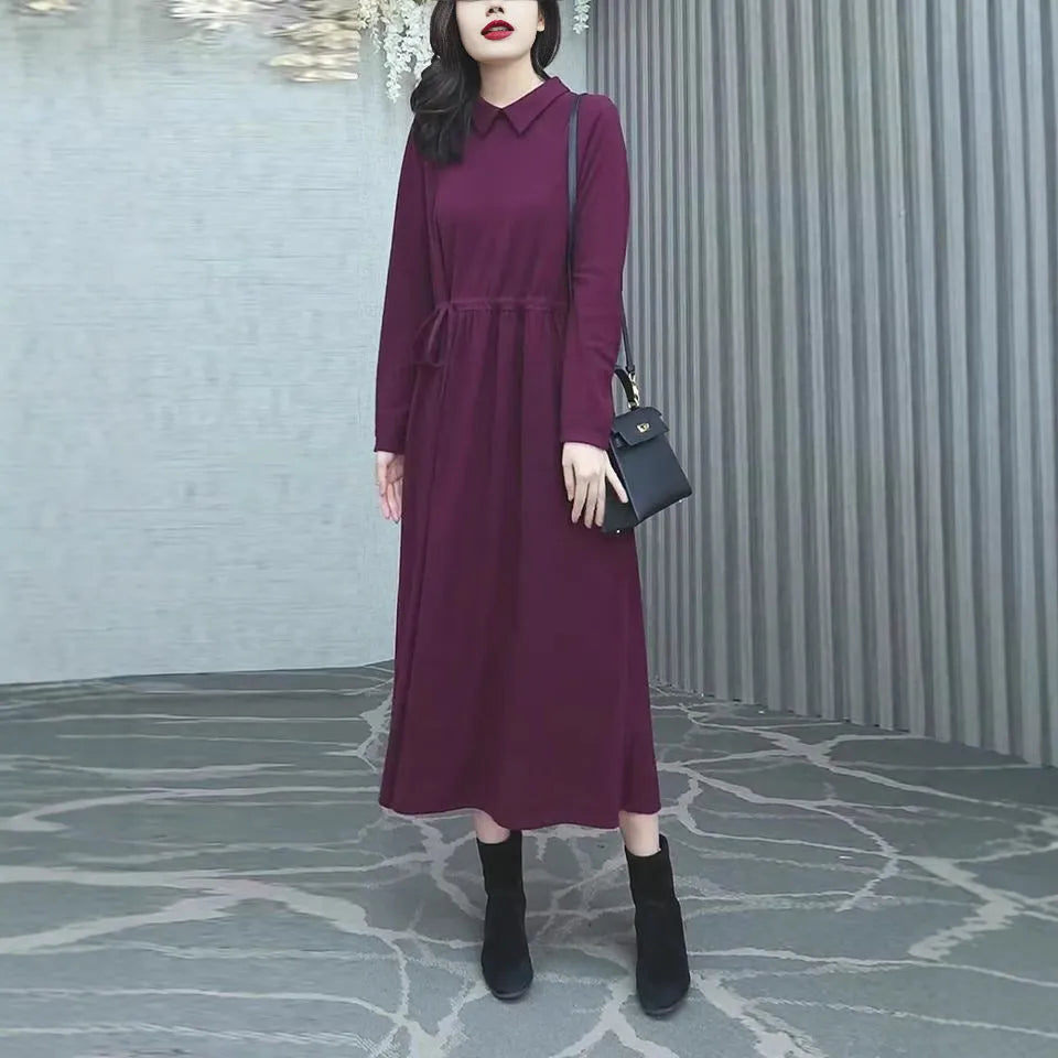 A purplish red plus size long sleeve dress for women, featuring a long skirt and urban commute style.