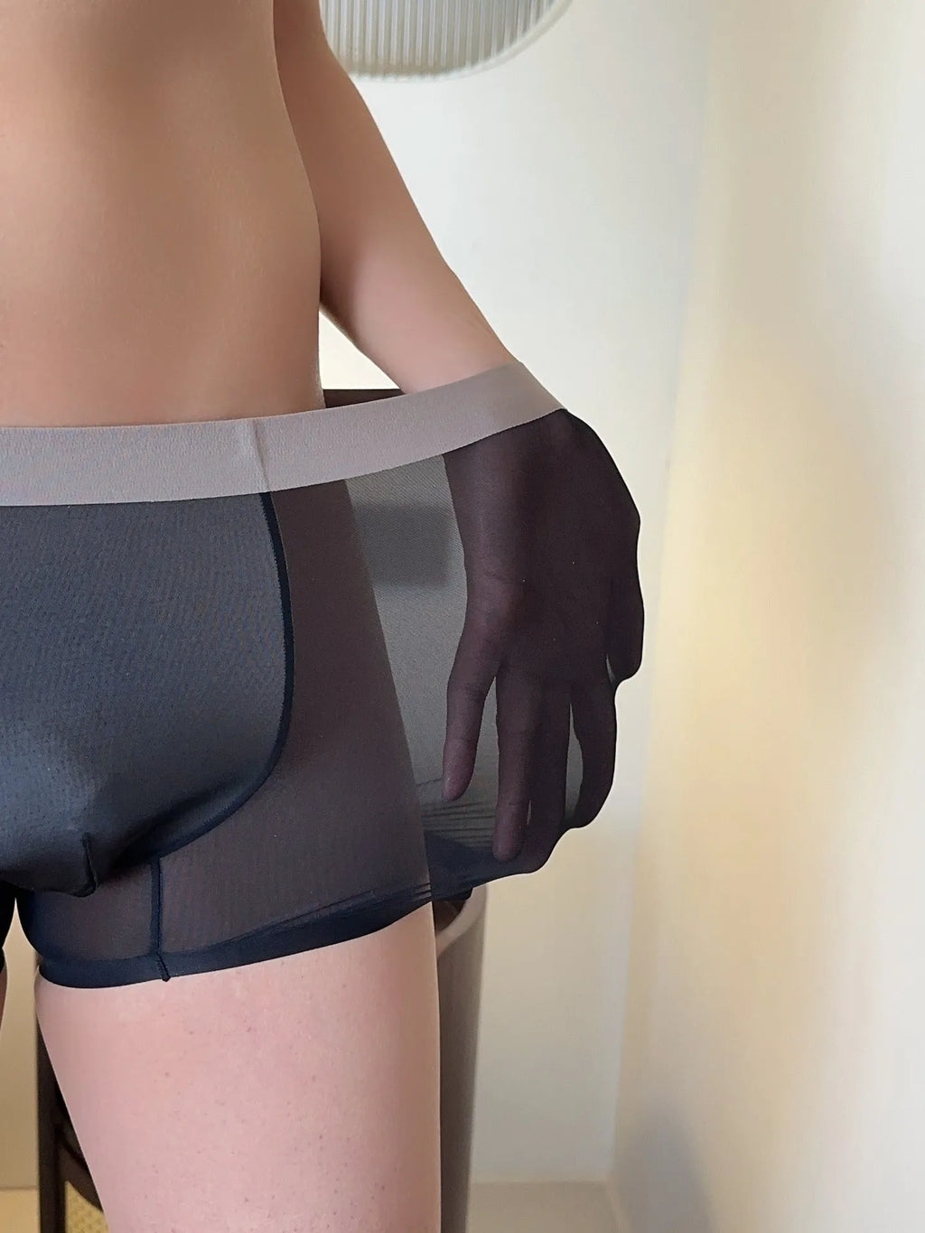 Seamless ice silk men's boxers in a solid colour on a mid-waist mannequin, showing honeycomb crotch detail.