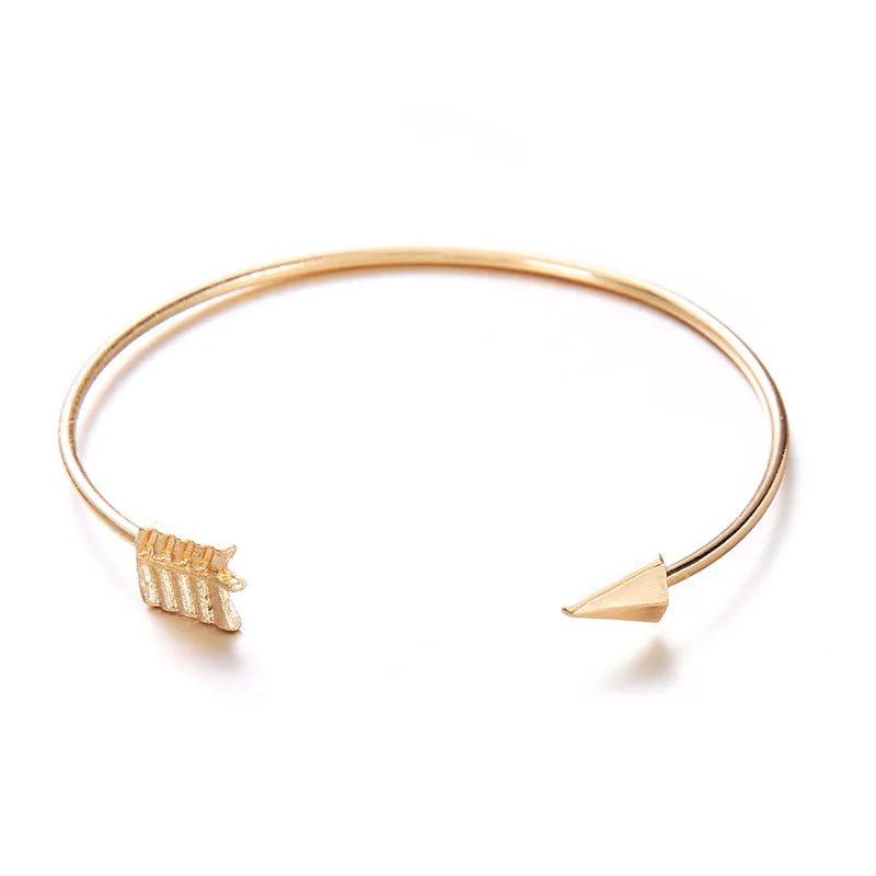 Gold vintage cuff bracelet for women with an arrow knot design detail.