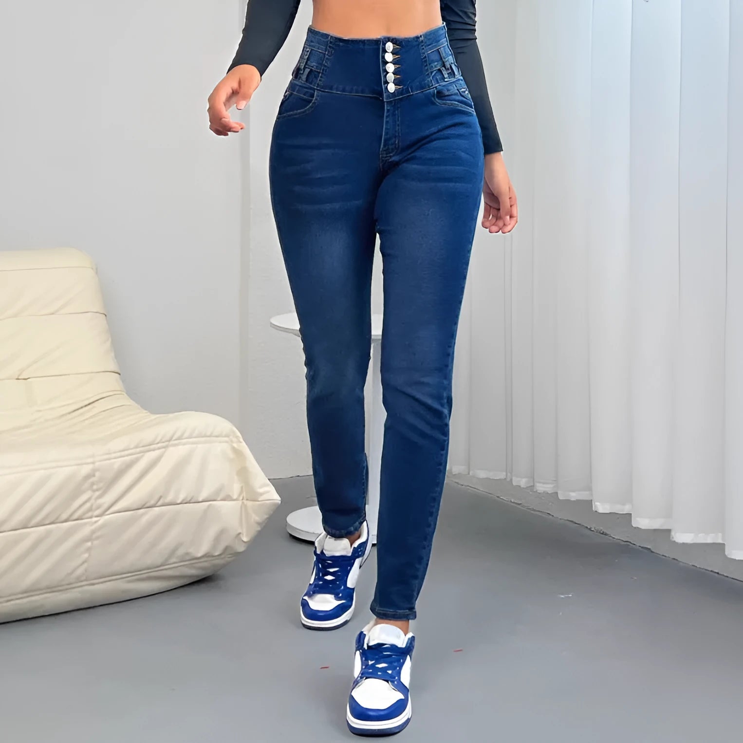 Dark blue women's straight-leg denim trousers with button details on a mannequin.