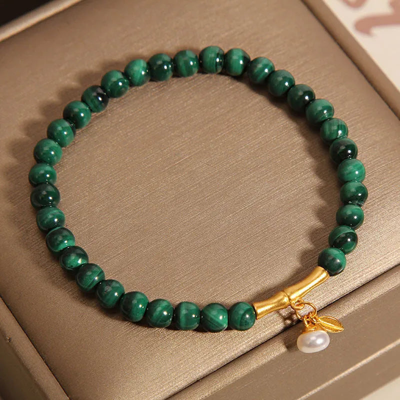 Women's white crystal bracelet with a raised lucky bamboo design centrepiece.
