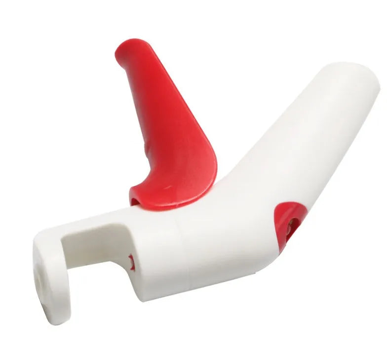 Close-up of a manual cherry pitter tool showing plastic handle and stainless steel mechanism.