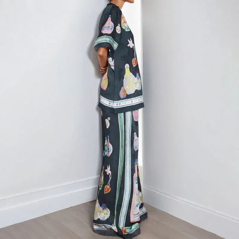 Black women's sleeve cardigan and trousers matching set with cartoon animation pattern.