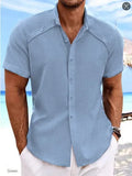 Man wearing a solid colour short sleeve Hawaiian casual shirt in a cotton blend fabric.