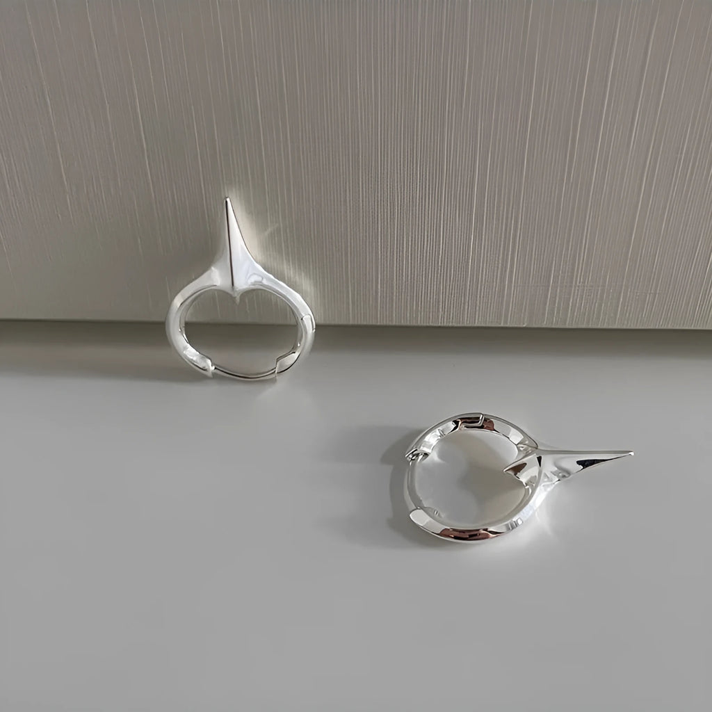 A pair of platinum-coloured geometric star-shaped clip-on earrings for women, made from electroplated copper.