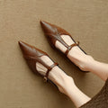 Brown pointed low-cut flat shoes with cowhide leather upper and metal decorative details