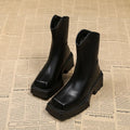 Black women's platform Martin boots with a square toe and back zipper on a neutral background.