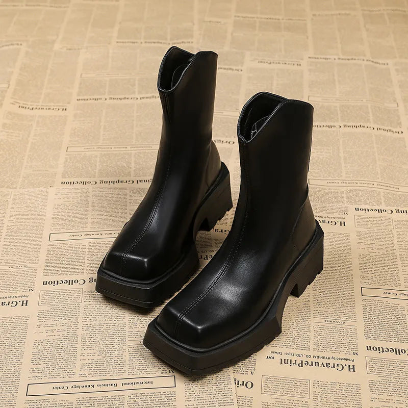 Black women's platform Martin boots with a square toe and back zipper on a neutral background.
