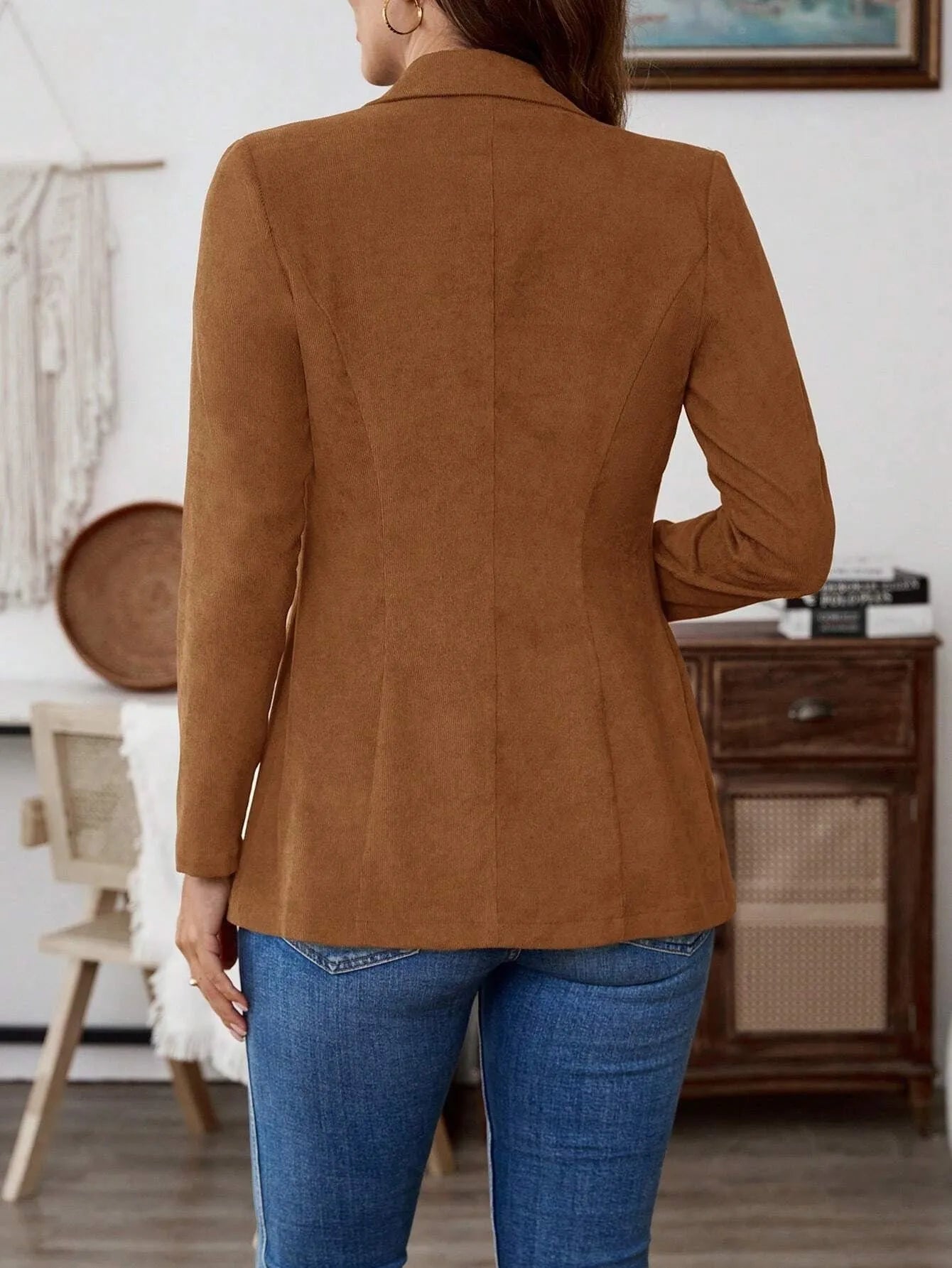 Brown men's single-breasted lapel coat with long sleeves on a hanger