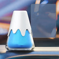 Glass car air freshener diffuser in purple, lime, laurel, or blue scent options on a car dashboard.