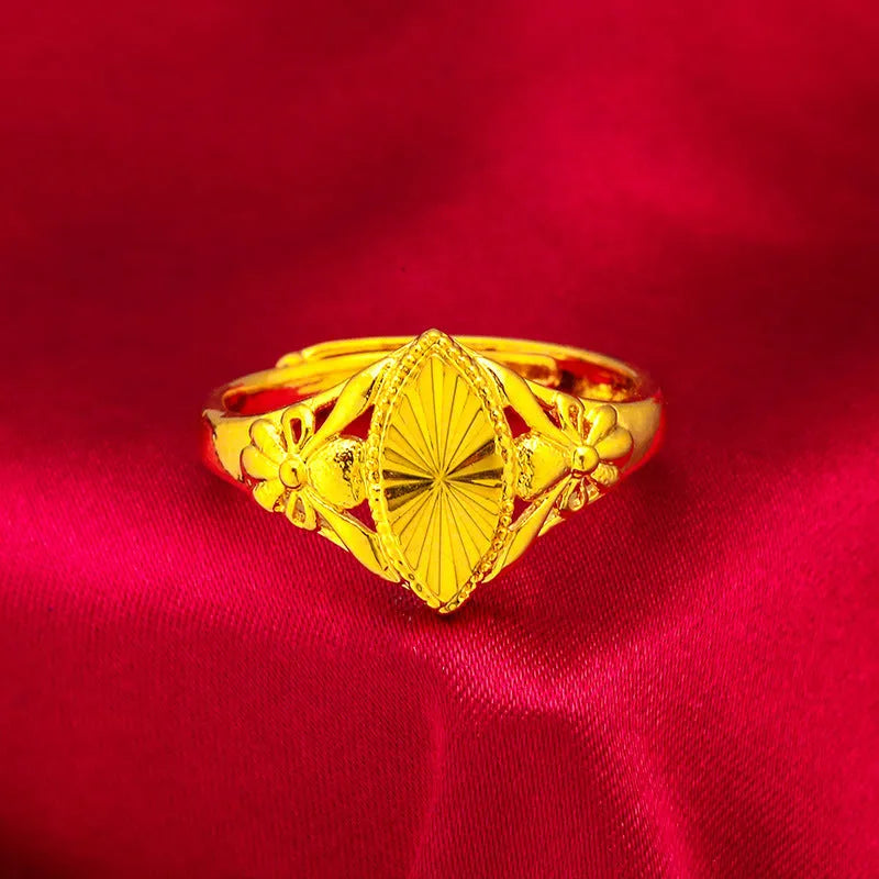 Gold coloured electroplated brass ring with a geometric open diamond flower design and textured details.