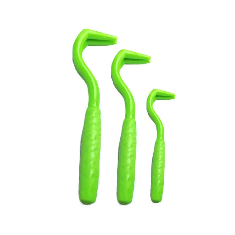 Three coloured ABS plastic tick hook removers for dogs on white background