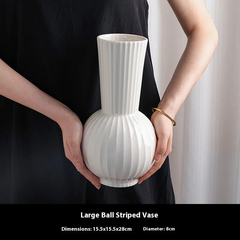 American country style ceramic vase with white base and blue stripes on living room table