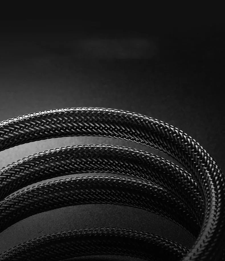 Close-up of a gold-plated HDMI connector on a black cable showing its aluminium foil and braided shielding layers.