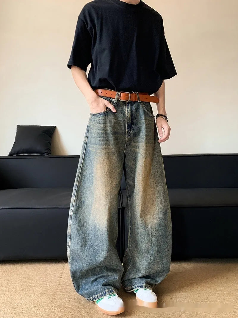 Retro blue distressed machete denim jeans for men with a wide-leg slim cut.