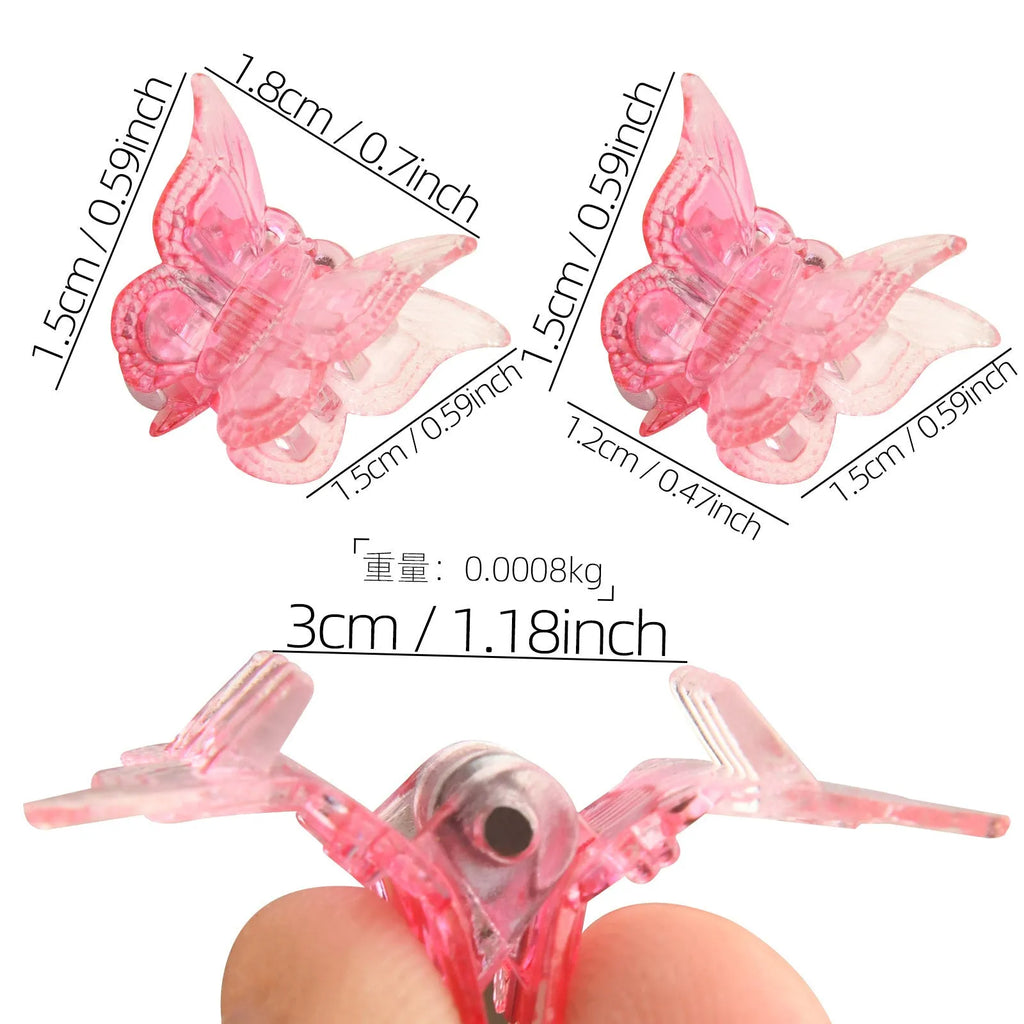 Assortment of glittery mini butterfly-shaped hair claw clips in multiple colours on a white background.