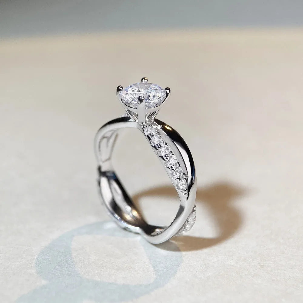 Geometric silver moissanite ring with twisted band and 1 karat centre stone in four-claw setting