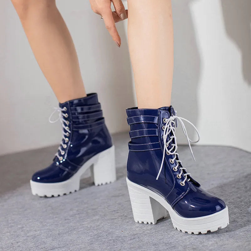 Women's black thick-heeled short boots with lace-up front and round toe on a waterproof platform.