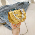 Silver laser pearl finish women's crossbody mini saddle tote bag with single shoulder strap.