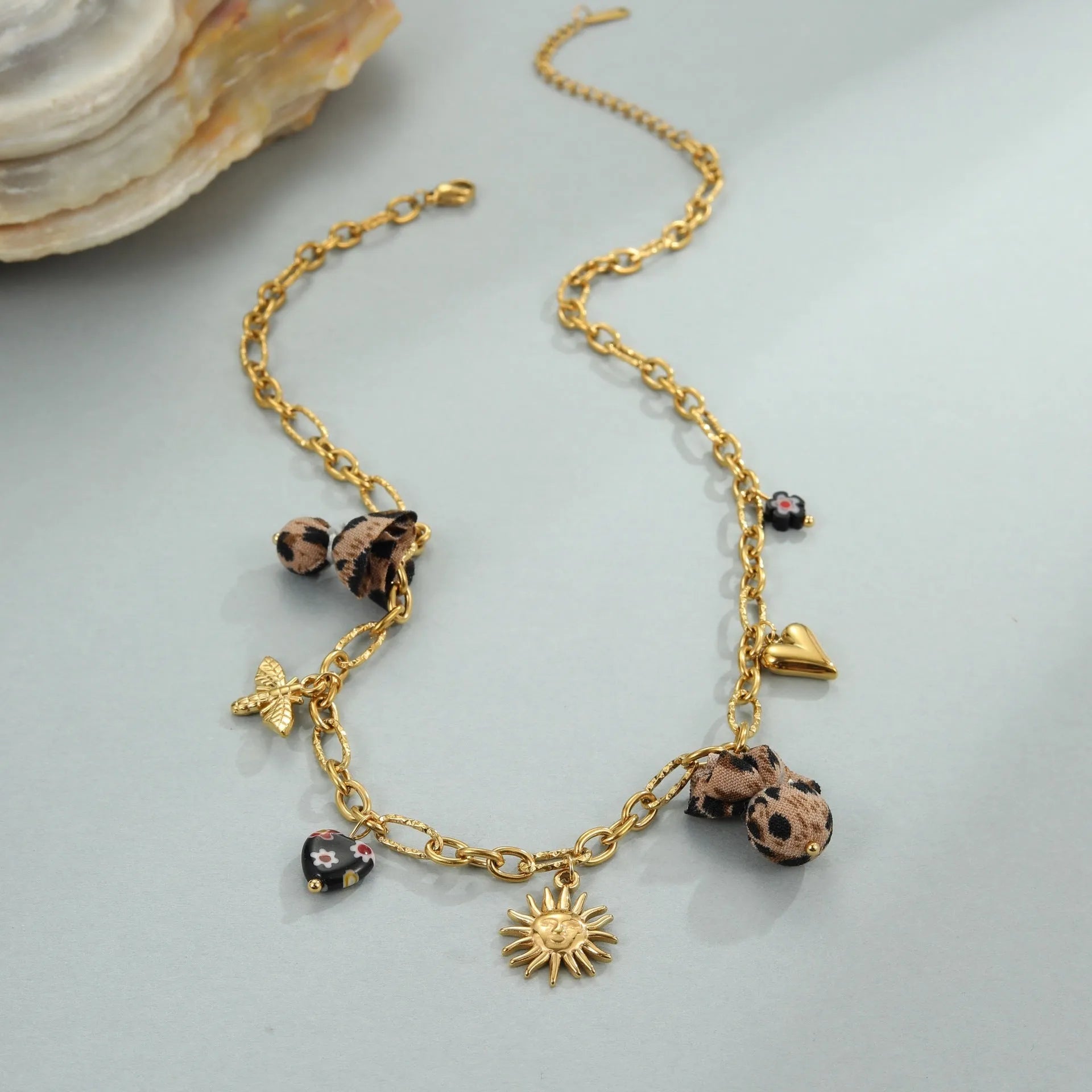 Stainless steel necklace with leopard, heart and flower pendant on adjustable chain