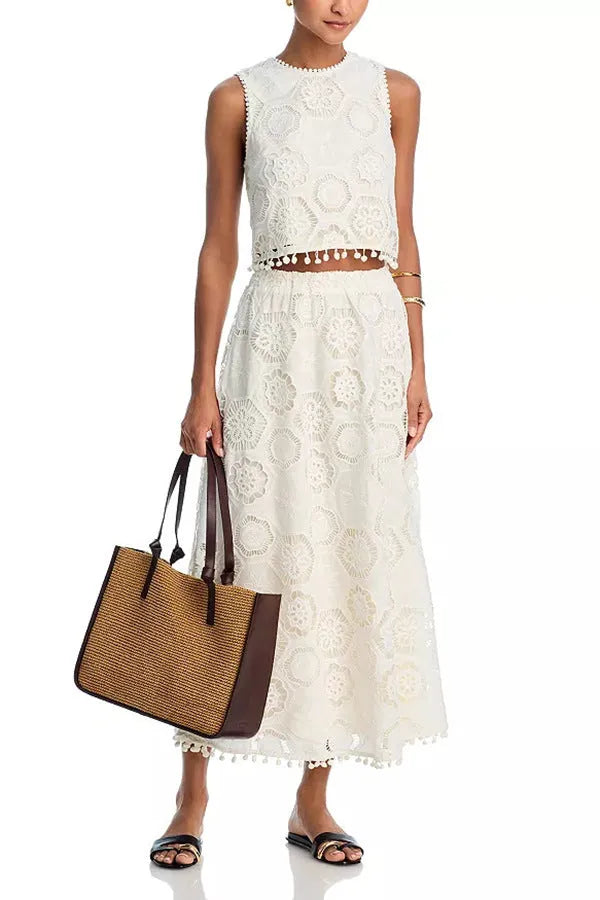 White women's retro suit with embroidery details showing sleeveless top and long skirt