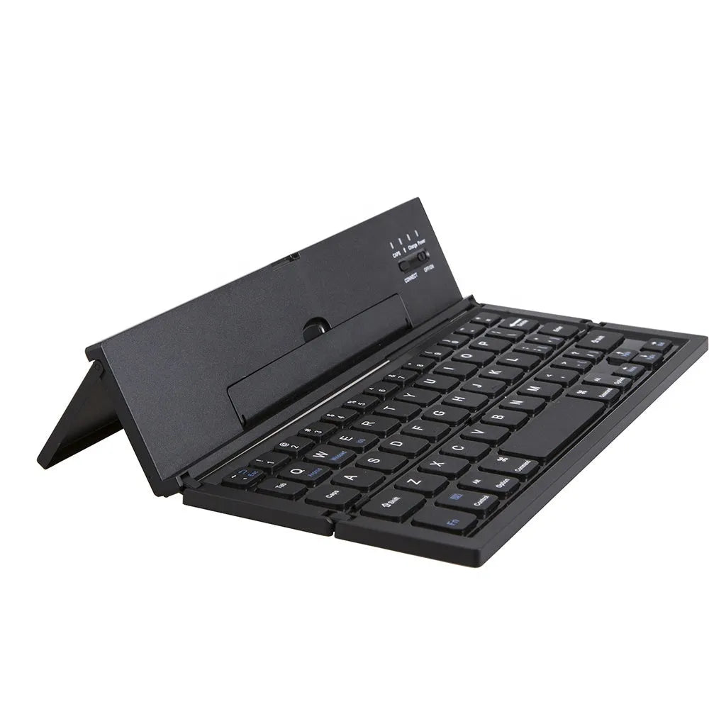 Black folding wireless Bluetooth keyboard shown open next to a tablet demonstrating its compact portable size.