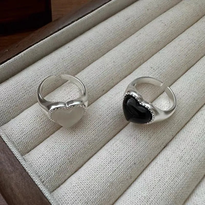 Adjustable open mouth sterling silver ring with a black heart-shaped agate stone.