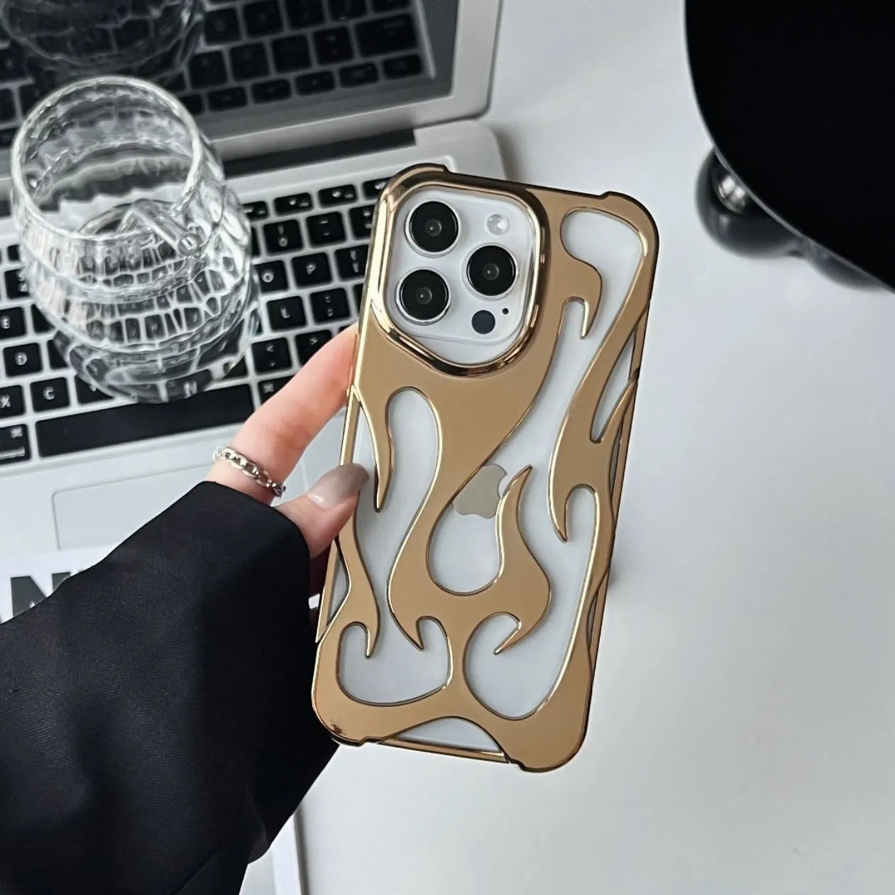 Electroplated hollow flame pattern design on a soft TPU iPhone case, shown in a silver finish.