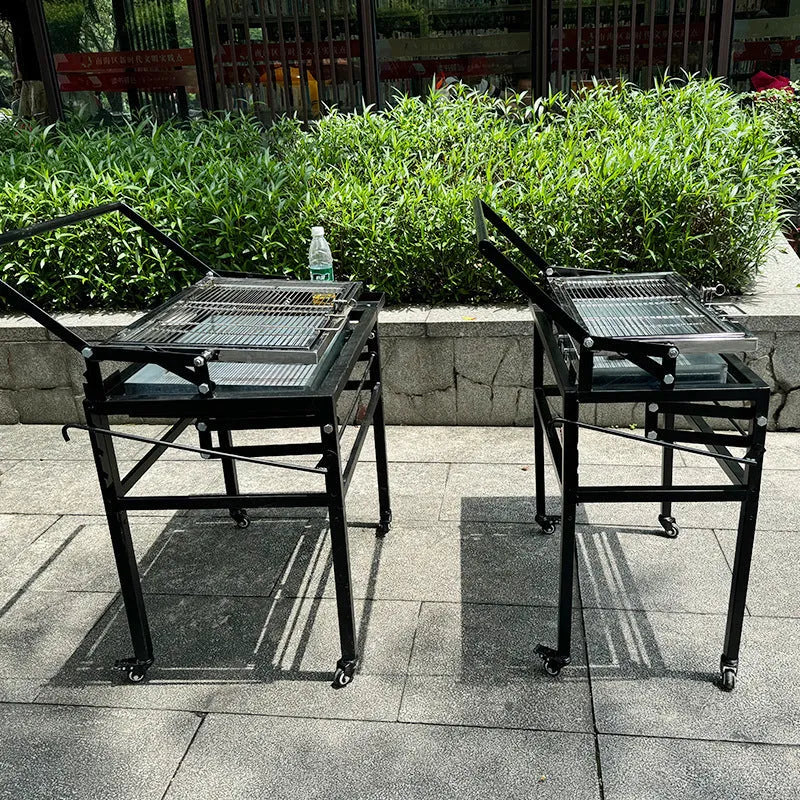 Large foldable Flip BBQ Stove charcoal grill with detachable metal frame set up in a garden.