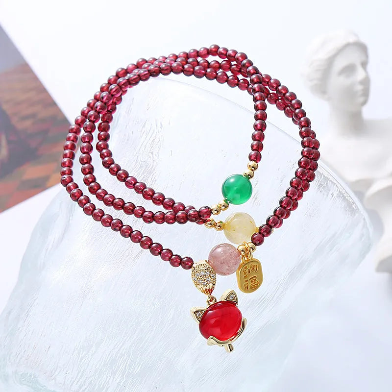Natural garnet fox bracelet with adjustable rope closure in purplish red colour