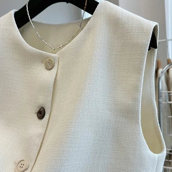 Women's milky white round neck bandage vest made from polyester, laid flat.