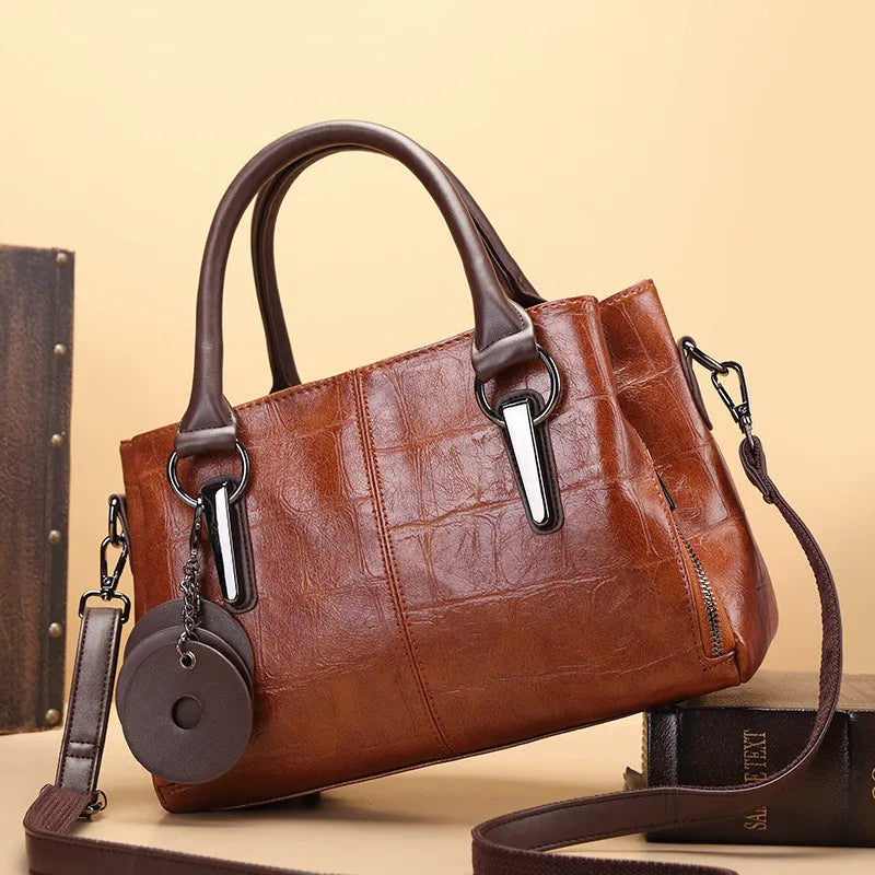 Horizontal square PU leather shoulder bag with contrasting stitching showing internal compartments including mobile phone section