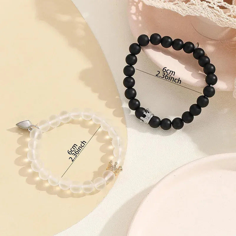 2pcs handmade glow-in-the-dark crown beaded bracelets in white and black with glass beads and luminous heart charm
