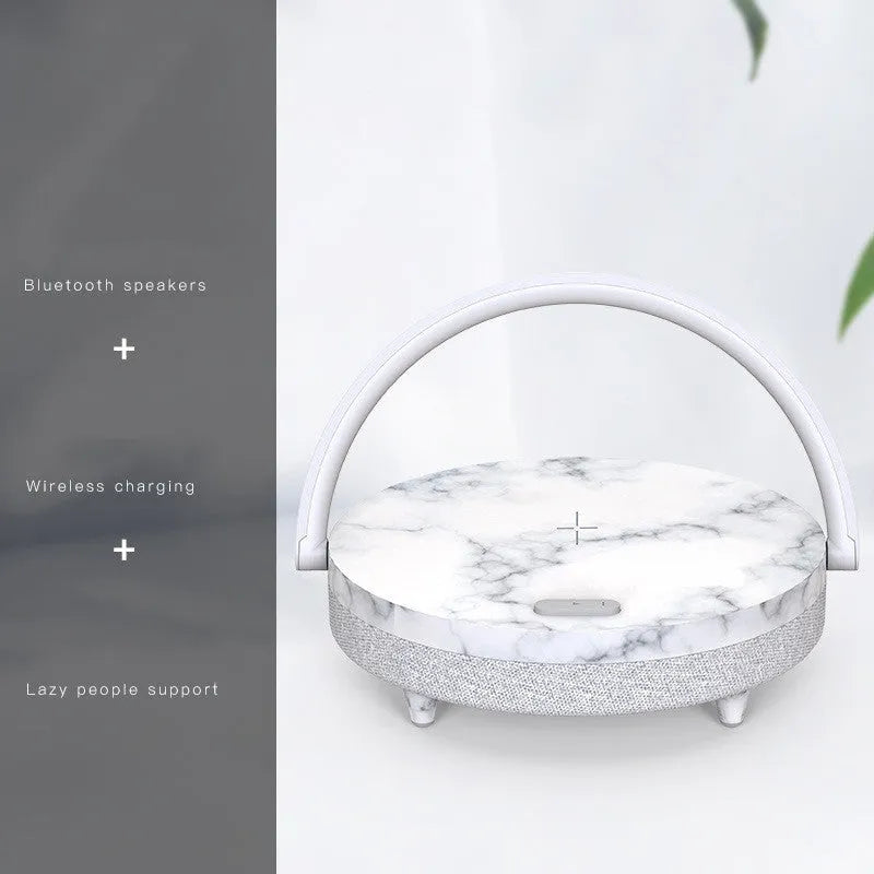 Wireless charging LED night light with Bluetooth speaker showing marble pattern finish and phone holder