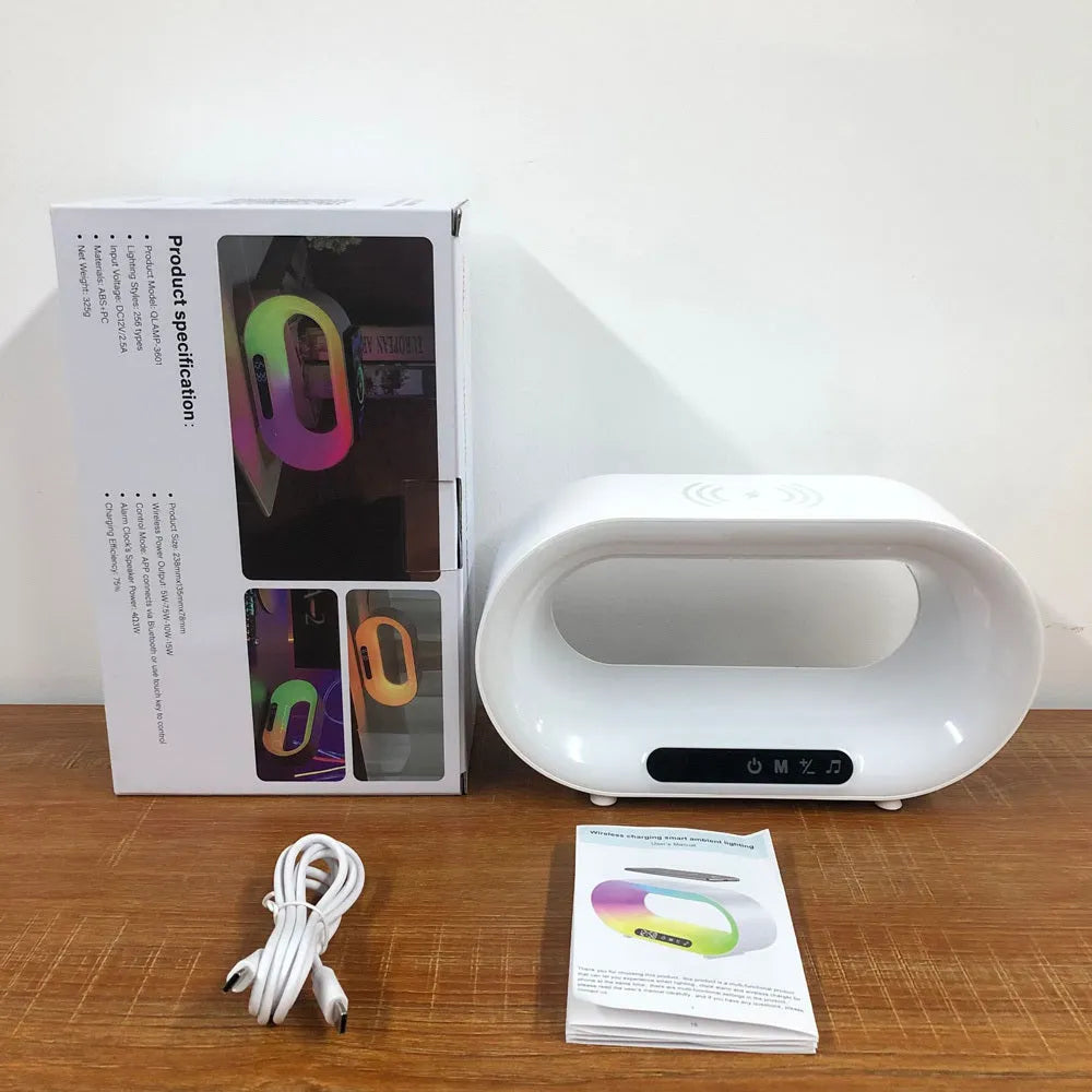 White 3-in-1 LED night light with wireless charger and alarm clock on a bedside table, 23.8cm tall