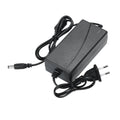 Stainless steel headlamp repair parts kit with power adapter options on a workshop bench.