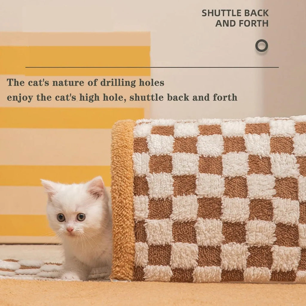 Brown plaid plush cat tunnel bed with a zippered side and central mat, shown on a wooden floor.