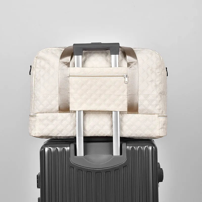 Large Oxford cloth travel bag in a solid colour with contrast stitching, shown with buggy and travel items.