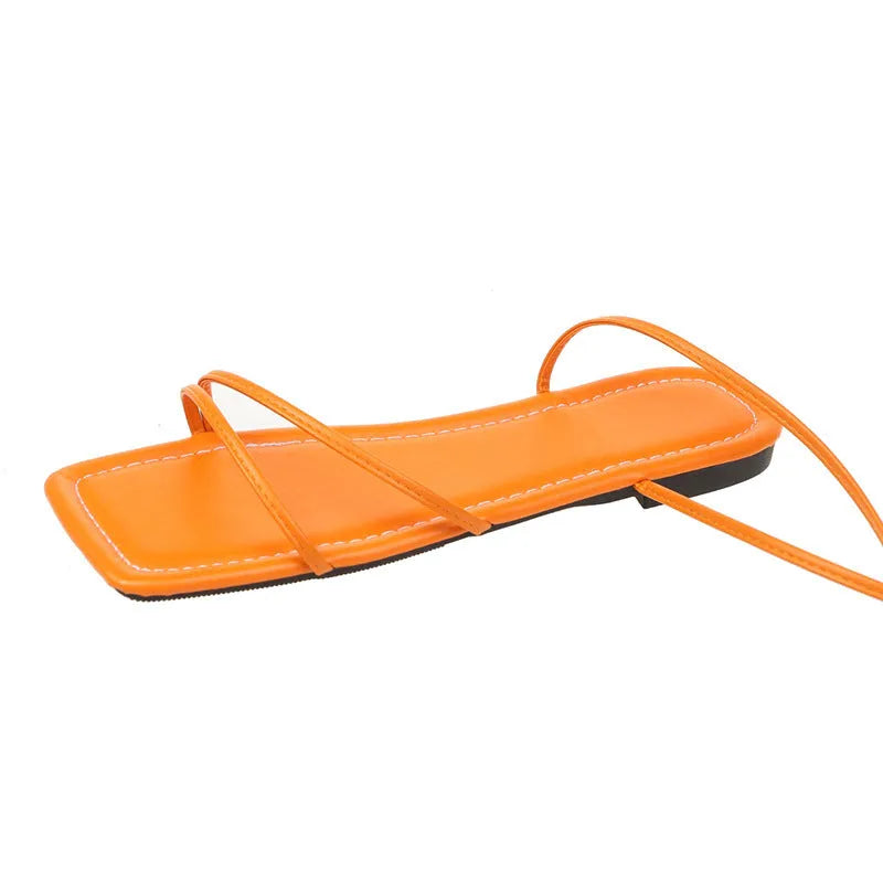 Women's white flat sandals with an ankle bandage cloth closure and square toe on a rubber sole.
