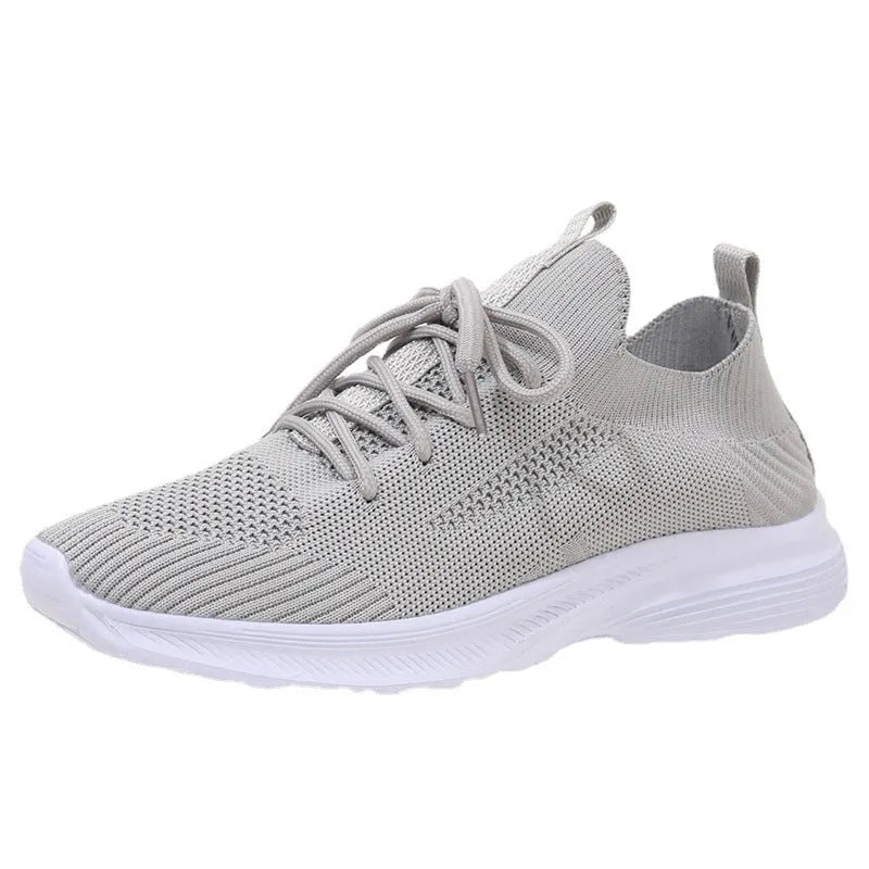 Women's mesh running shoes in creamy white with flat rubber sole and low-top design