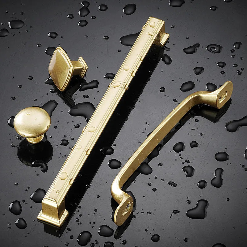 Gold T-shaped single hole cabinet handle with aluminium alloy construction.