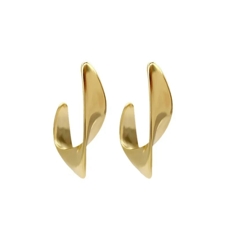 Gold and silver geometric twisted metal earrings with round design elements